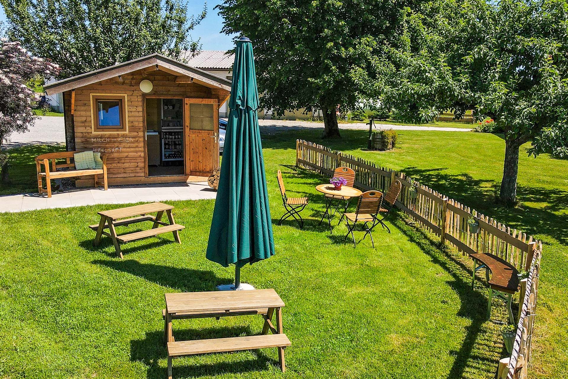 Holzhütte mit Hofladen und Bänken, um draußen zu sitzen